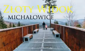 Złoty widok Michałowice. Dwoje ludzi na platformie widokowej z metalową kratownicą i ławkami, w tle góry i las.
