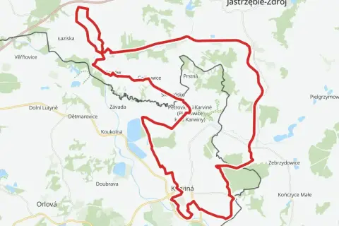 Mapa z zaznaczonym czerwonym szlakiem rowerowym, biegnącym przez tereny przygraniczne Polski i Czech, w okolicach Jastrzębia-Zdroju i Karwiny.