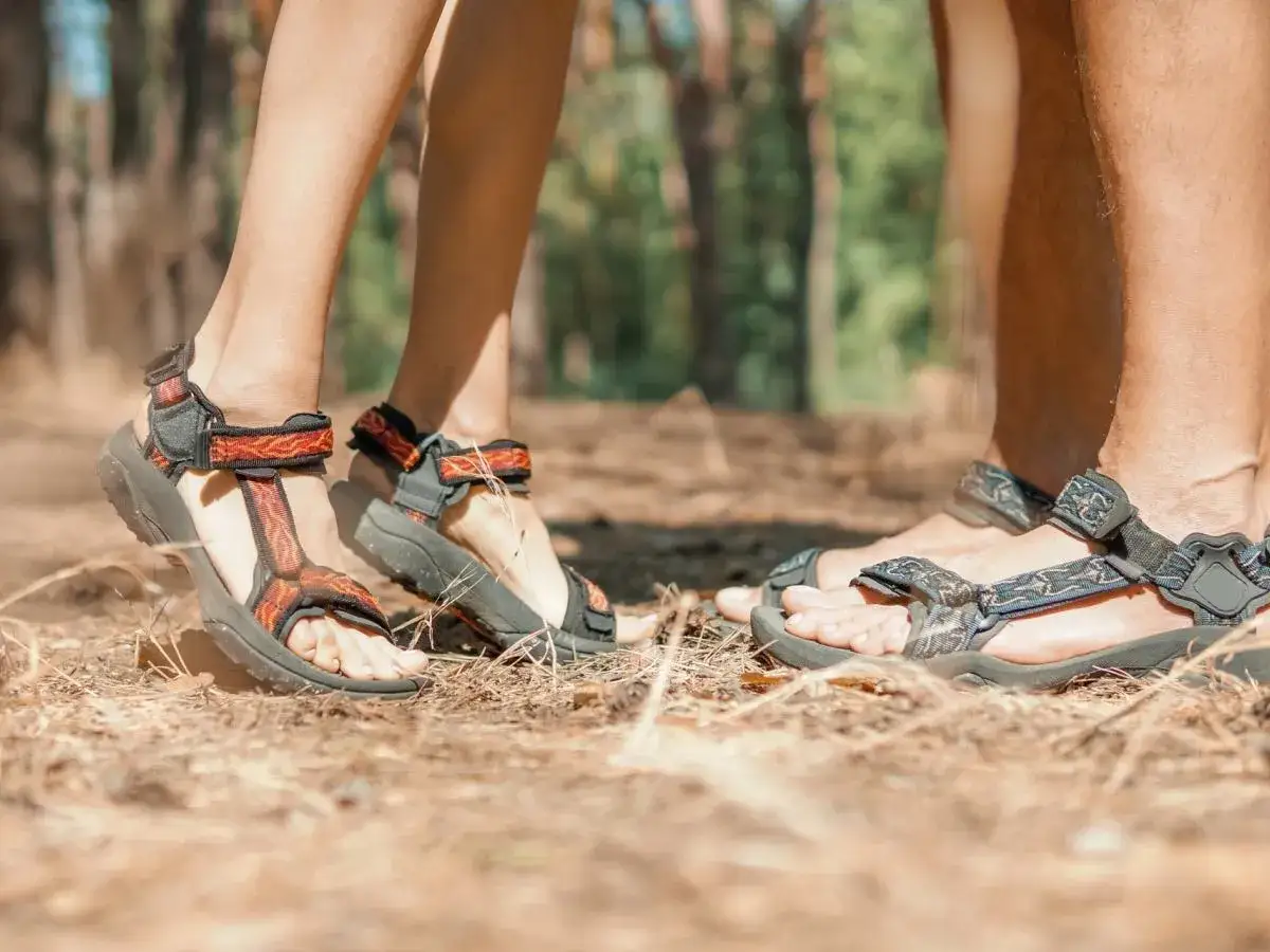 Sandały Teva na nogach w lesie. Teva to firma znana z wytrzymałego obuwia outdoorowego.